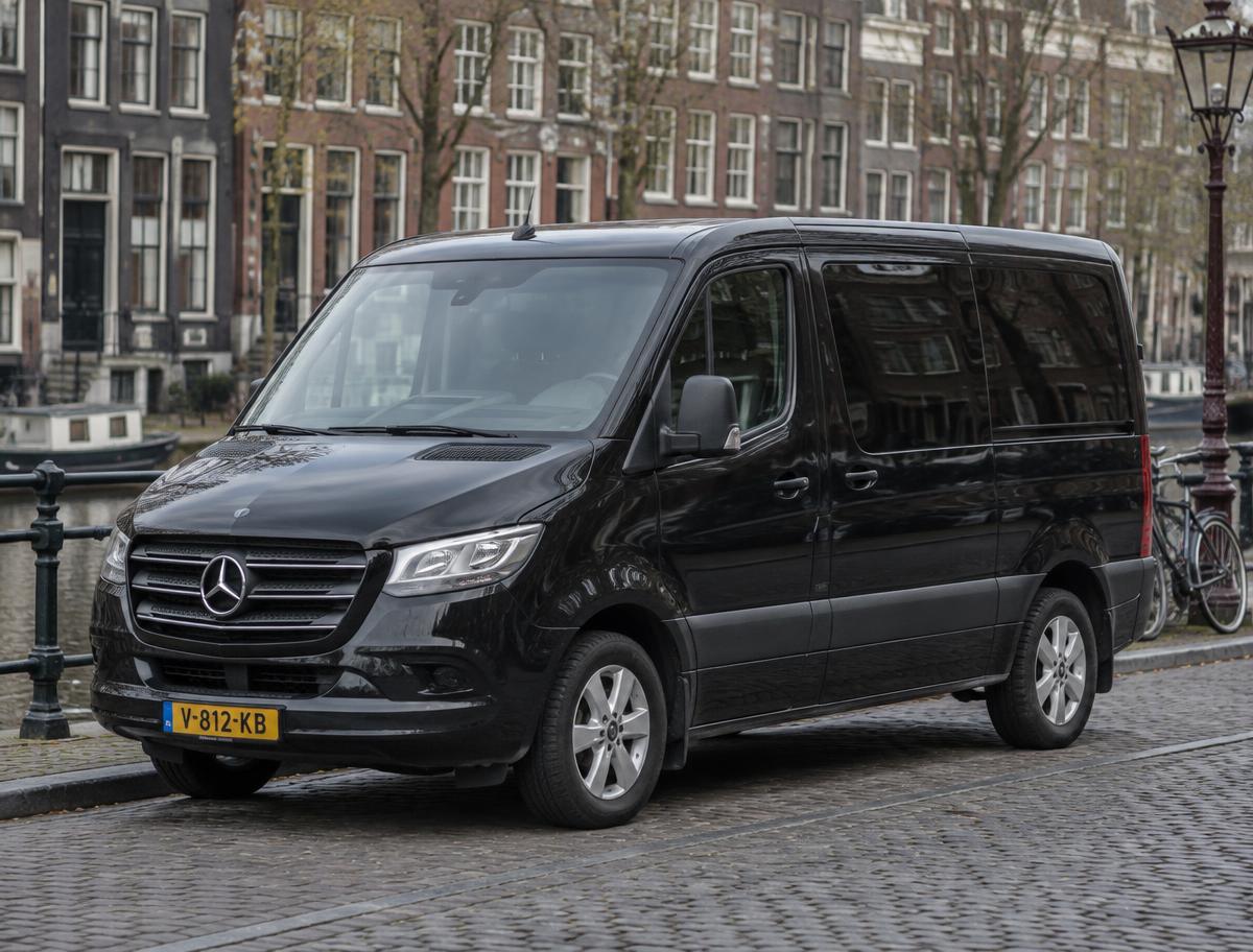 Black Mercedes-Benz Sprinter 8-passenger shuttle van on a Dutch street